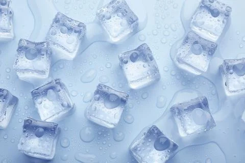 Crystal clear ice cubes on light blue background, flat lay 스톡 사진