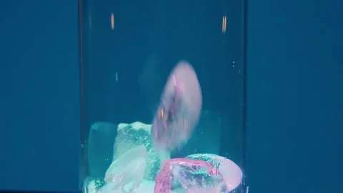 Crystal Clear Ice Cubes Tumbling into a Glass with a Splash, a Refreshing Scene Stock Footage 263369774