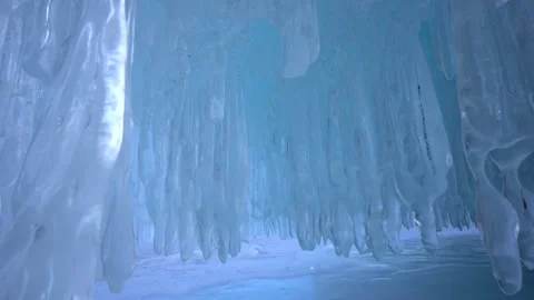 Crystal clear ice giant transparent icicles with patterns hanging, cave ceiling  Stock Footage 317963448