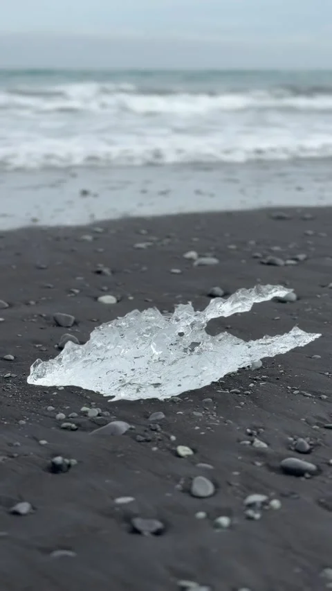  Crystal-clear ice shards scattered across Diamond Beach's black sands in Icelan Stock Footage 312232834