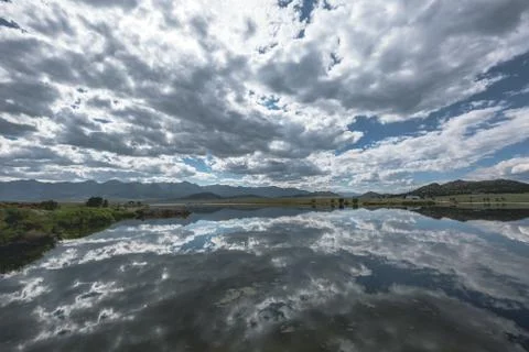 Crystal clear lake with cloud reflection Stock Photos