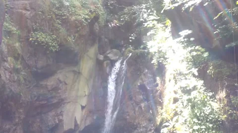 Crystal clear mountain waterfall with sun flares stock video footage Stock Footage 50238584