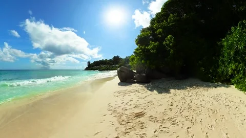 Crystal-clear ocean meeting soft white sand beach. Seychelles, La Digue. Stock Footage 319971269
