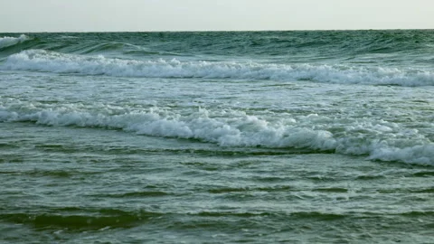 Crystal-clear ocean waves gently roll toward the shore in smooth slow motion. Stock Footage 340959710