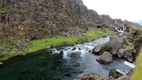 Crystal clear Öxará river flowing through Almannagjá fault, Iceland Stock Footage 334957355