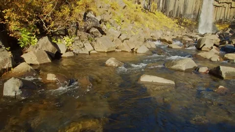 Crystal Clear River Flowing Over Volcanic Rocks in Iceland Stock Footage 320507569
