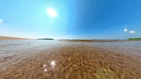 Crystal clear river tidal waves on the sandy beach. Meditative and calm, sunny Video stock 255972478