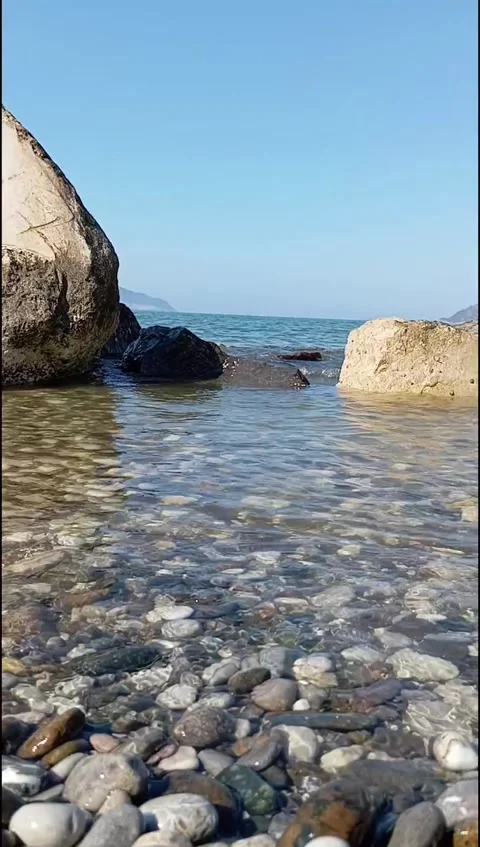 Crystal-clear sea waves gently wash over naturalGentle Sea Stock Footage 339266155