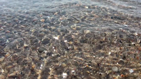 Crystal Clear Shallow Water Flowing Over Colorful Pebbles in Summer Stock Footage 340516967