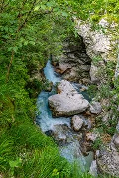 Crystal Clear Stream Cascading Through Ancient Rocks in Soca Valleys Lush T.. Stock Photos