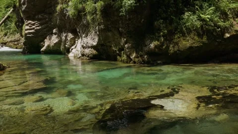 A crystal-clear stream flowing through the Julian Alps Video stock 304592489
