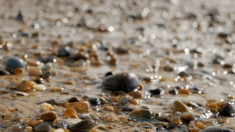 Crystal clear stream flows over the pebbles. Sparkling sun glare. Bokeh. Video stock 108625300