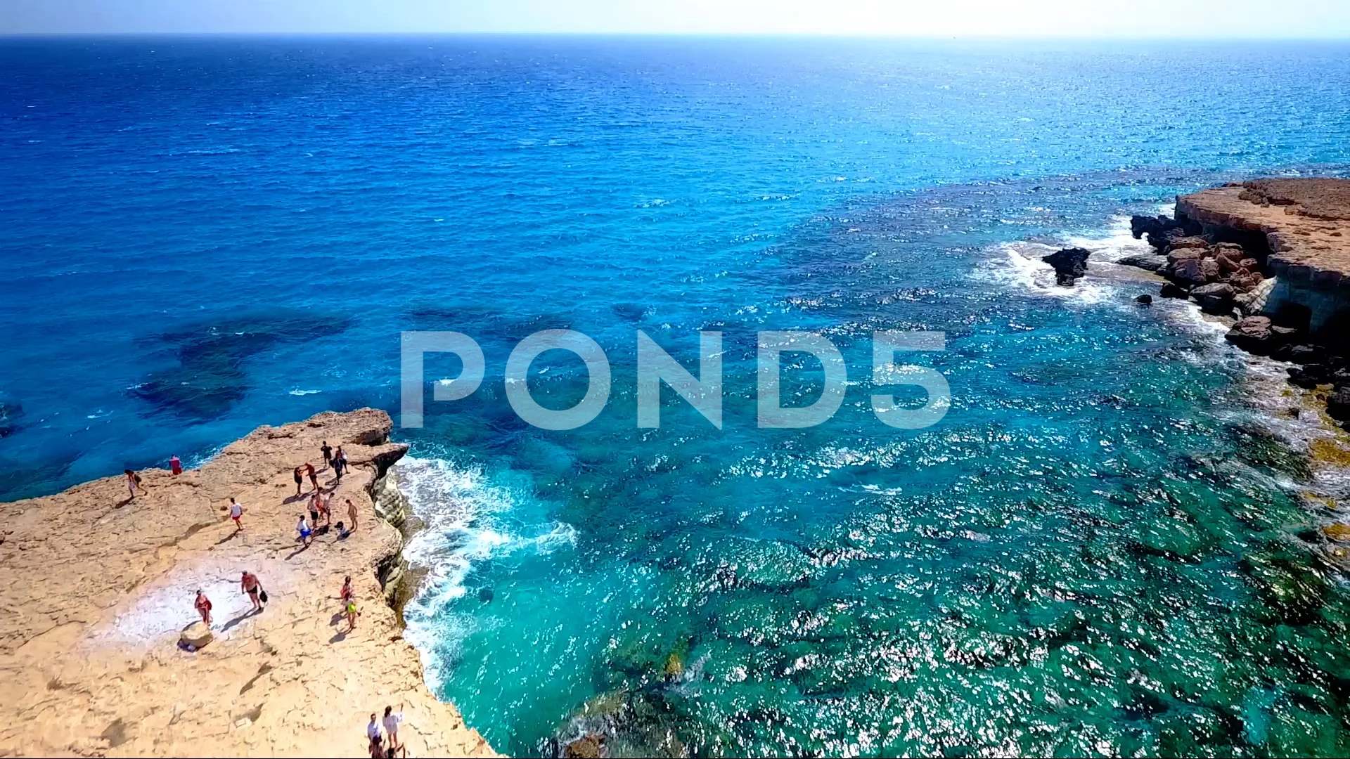 Turquoise colored crystal clear water at a rocky island