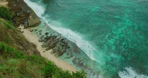 Crystal clear turquoise ocean water hitting sandy Diamond beach in Nusa Penida Stock Footage 344752611