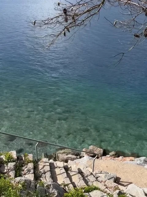 Crystal Clear Turquoise Sea Water and Stone Steps Leading to Beach Video stock 340263933