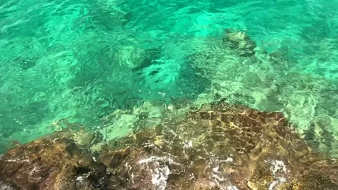 Crystal clear turquoise water over rocks slow motion Stock Footage 339880456