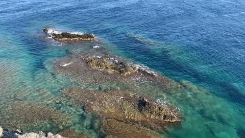 Crystal Clear Turquoise Waves Rolling Over Rocks in Mediterranean Sea Stock Footage 150677975