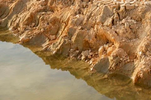 Crystal clear water at clay quarry pond. Stock Photos