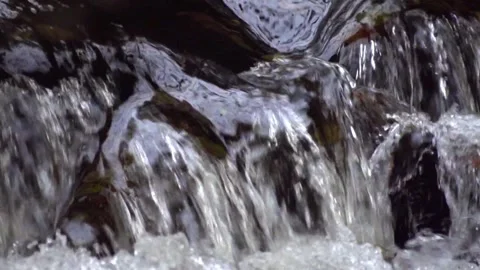 Crystal clear water falling down the stream Stock Footage 143350040