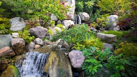 Crystal clear water flowing over rocks at Frederik Meijer`s garden in Grand.. Stock Footage 329660312