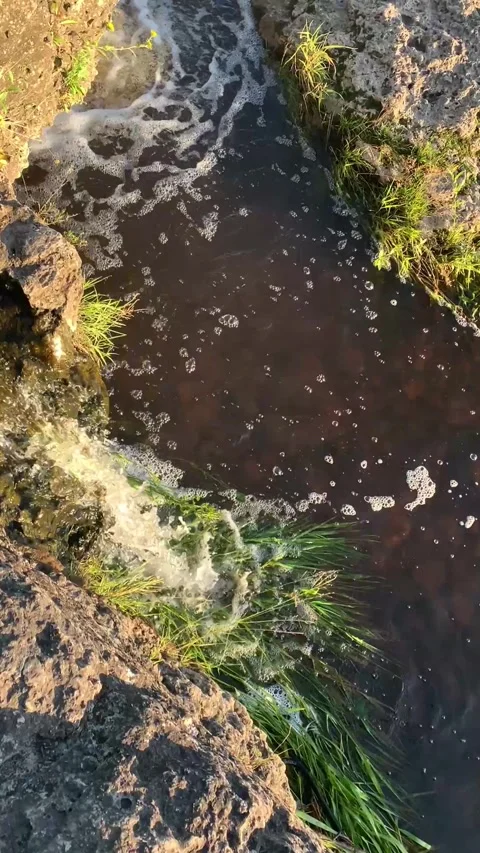 Crystal-clear water flowing over rocks in a natural waterfall. Stock Footage 341267796