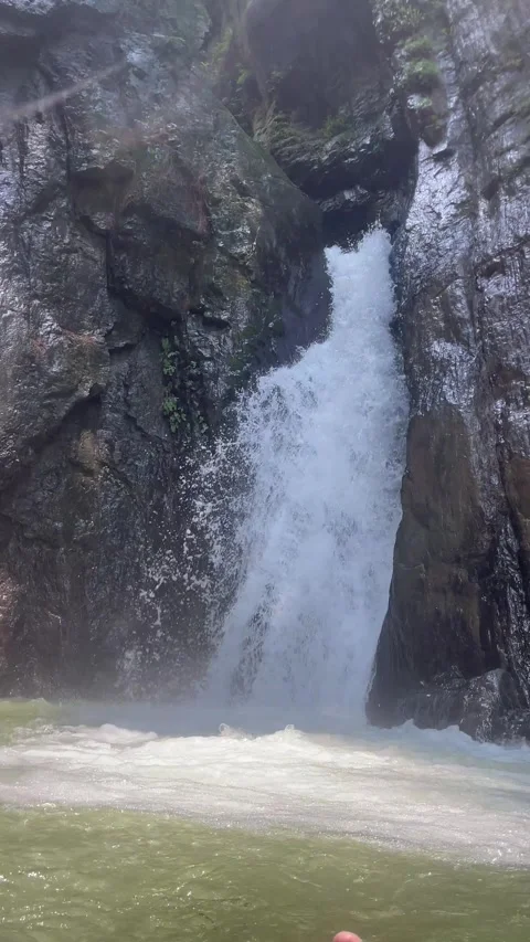 Crystal Clear Water Flowing Through Hidden Mountain Waterfall with Lush Greenery 動画素材 343611651