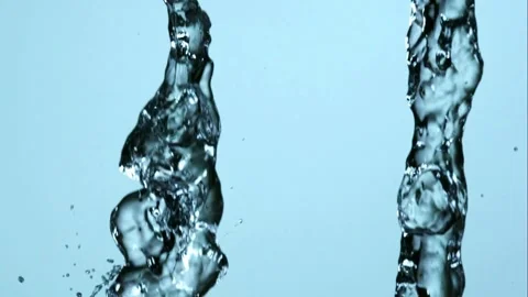 Crystal clear water flows down against blue Stock Footage 326754044