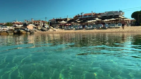 Crystal-clear water gently laps the shore. Nikiti, Greece Vídeo Stock 338347210