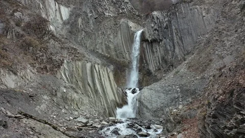 Crystal Clear Waterfall Flowing Through Rugged Mountains Video stock 303589478