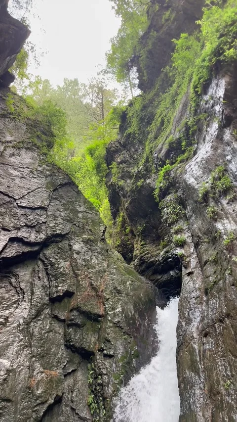 Crystal Clear Waterfall Flowing Through Rocky Mountain Gorge in Abbottabad  스톡 동영상 343610805