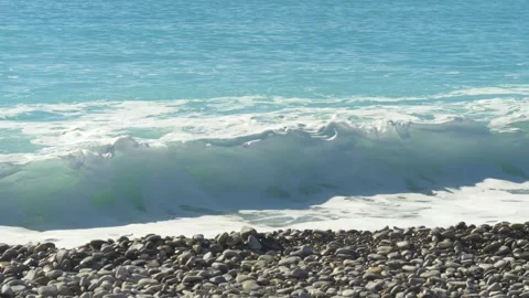 Crystal clear wave on rocky beach coast Stock Footage 334656767