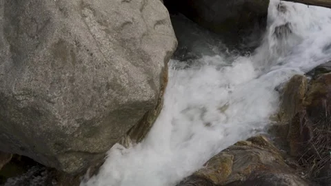 Crystal clear white river flowing through huge boulders and rocks. Video stock 280262027