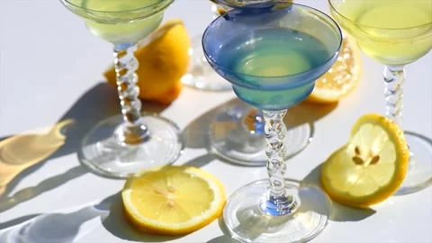 Crystal colorful stemware set with reflection over white background. Limoncello Stock Footage 283839717