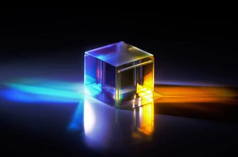 A crystal cube reflects colored rays Stock Photos