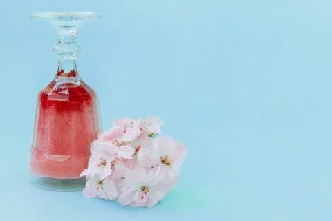 The crystal glass contains a gradient raspberry smoothie. Stock Photos