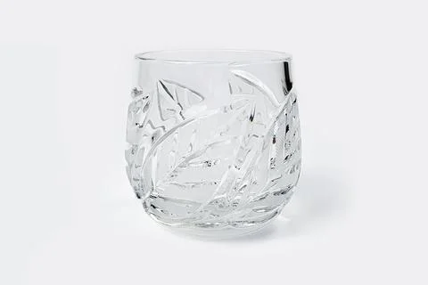 Crystal glass with leaf pattern isolated on white background. Front view Stock Photos