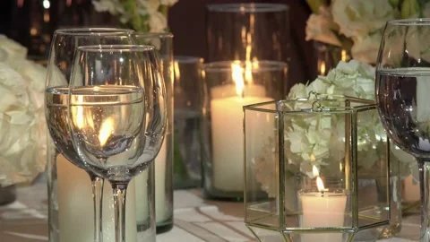 Crystal glasses on a romantic table lit with candles. Video stock 191290138
