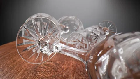Crystal goblets are randomly placed on their sides on a wooden table. Stock Footage 211399010