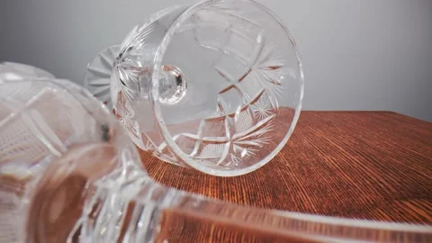 Crystal goblets are randomly placed on their sides on a wooden table. Stock Footage 211399049