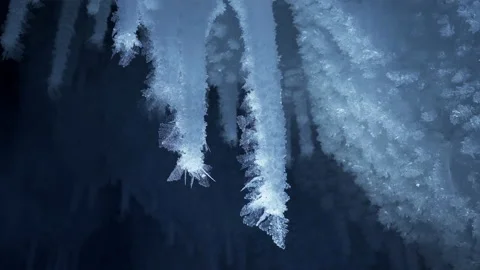 Crystal icicles, sharp ice stalactites, frozen blue ice and snowflakes. Macro Stock Footage 179291130