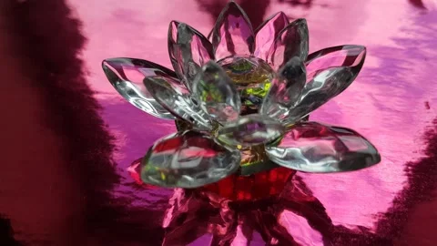 Crystal lotus on red table with light reflection. Muladhara chakra symbol. Stock Footage 193993253