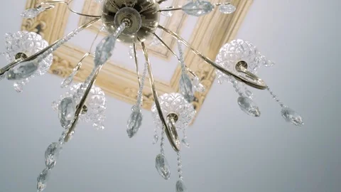 Crystal-powered chandelier hanging on the ceiling Stock Footage 123587666