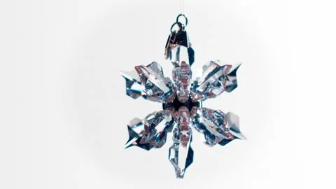 Crystal snowflake on a white background spins and sparkles. Decorations. Stock Footage 219011888