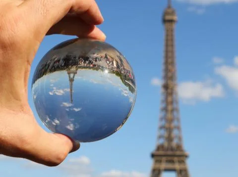 Crystal Sphere on the hand and the Eiffel Tower in Paris Fotos de archivo