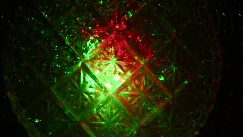 The crystal surface passes through itself rays of green and red light. 動画素材 305020817