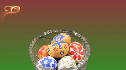 Crystal vase rotates with Easter eggs. Appearance of german text 'Frohe Ostern!' 動画素材 74103439