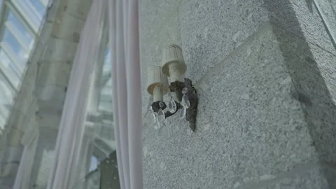 Crystal Wall Sconce on Stone Wall Beside Conservatory Window Stock Footage 345304013