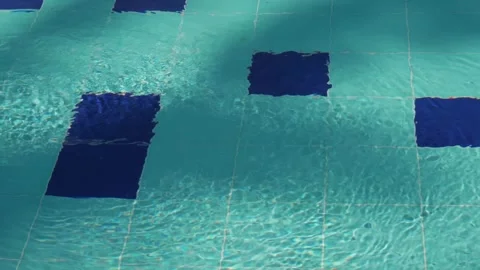 Crystal Water of the Pool with Light and Dark Blue Tiles and Jet-Generated Waves Видео 248917041