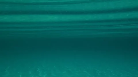Crystal waters ripple beneath sunlit sky. Trani Ammouda, Greece Stock Footage 339609518