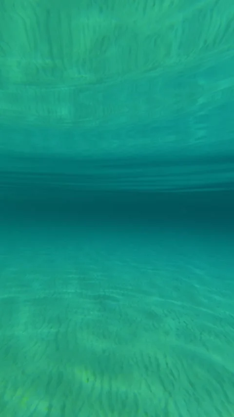 Crystal waters ripple under clear blue skies. Trani Ammouda, Greece. Vertical Vídeos de archivo 338358130
